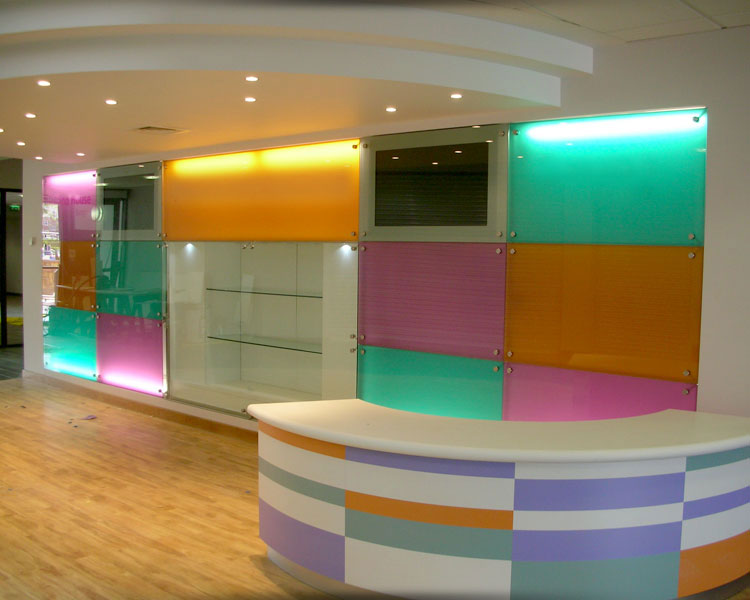 Colourful curved counter with display feature wall.