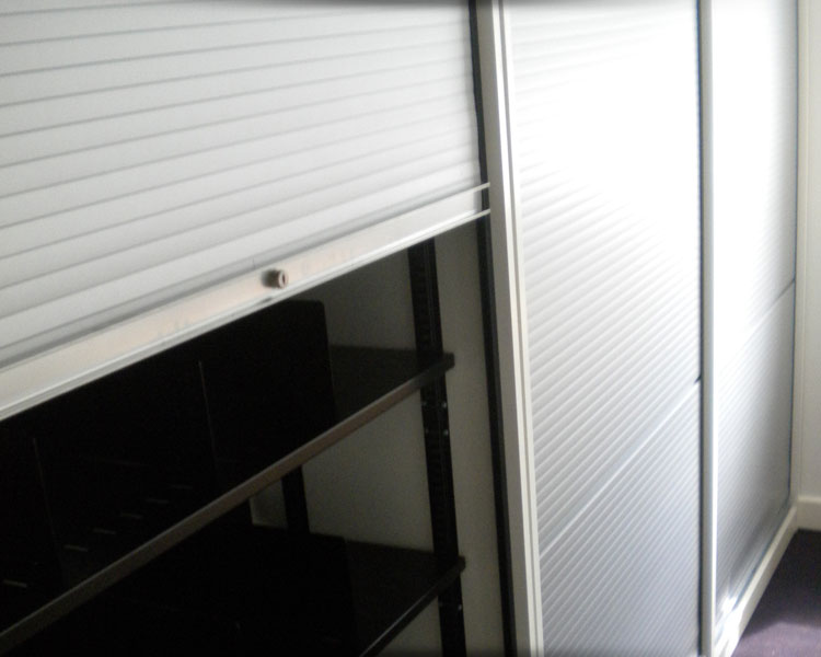 Tall tambour storage units with shutters down.